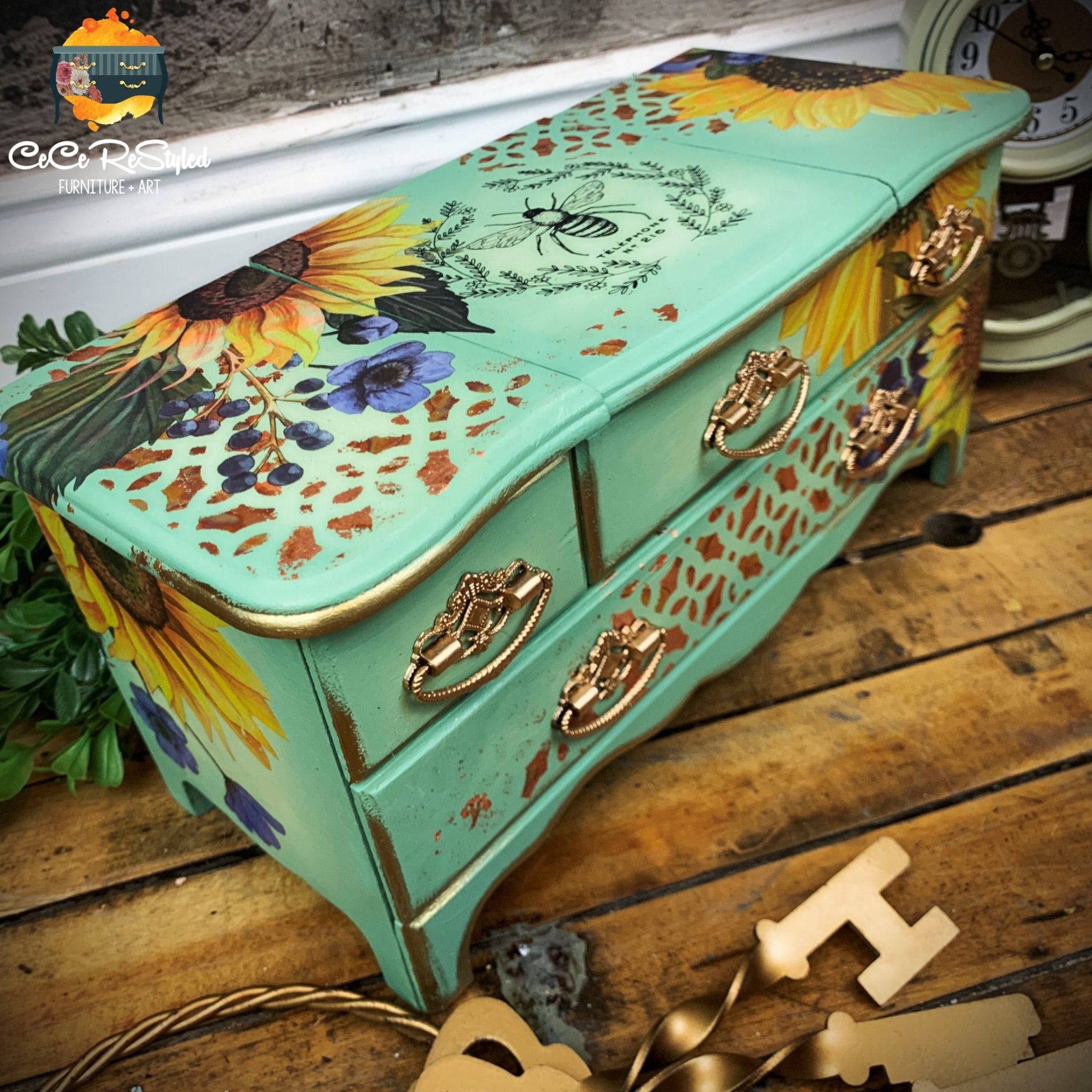 A vintage table top jewelry box refurbished by CeCe ReStyle is painted Spring green with gold accents and features ReDesign with Prima's Sunflower Fields on it.