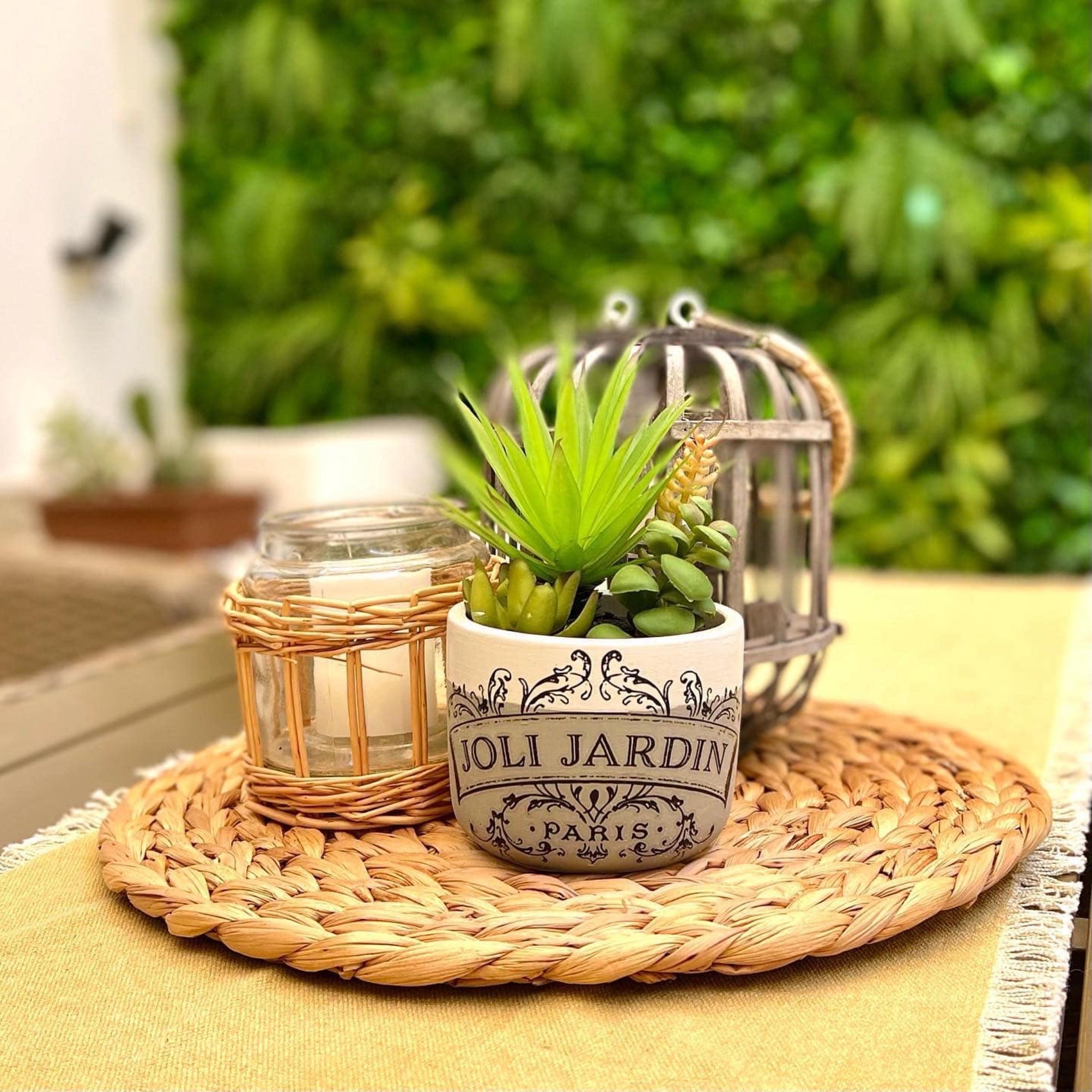 A small ceramic planter pot is painted light and dark beige and features ReDesign with Prima's Classic Vintage Labels transfer on it.