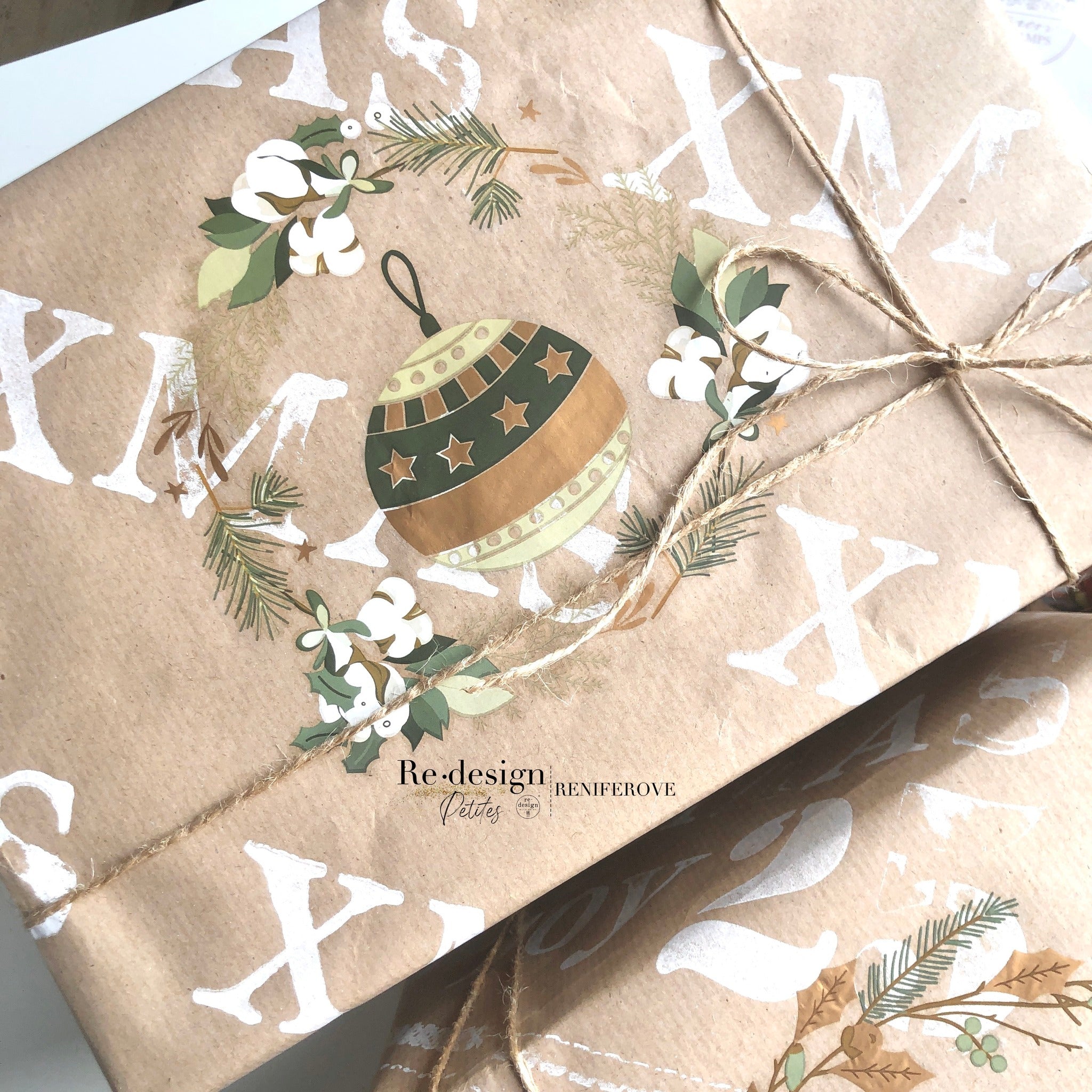 A brown paper wrapped gift created by Reniferove features ReDesign with Prima's Holiday Spirit small transfers on it.