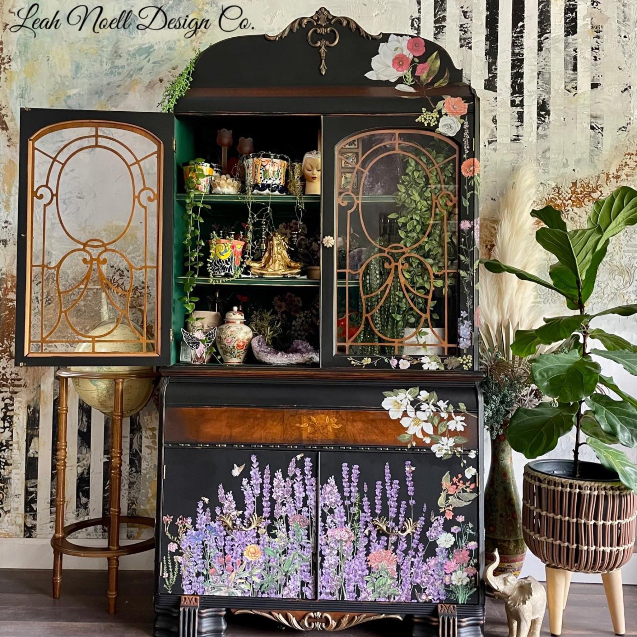 A vintage hutch cabinet refurbished by Leah Noell Design Co. is painted flat black with natural wood accents and features ReDesign with Prima's Champs de Lavende transfer on its 2 bottom doors.