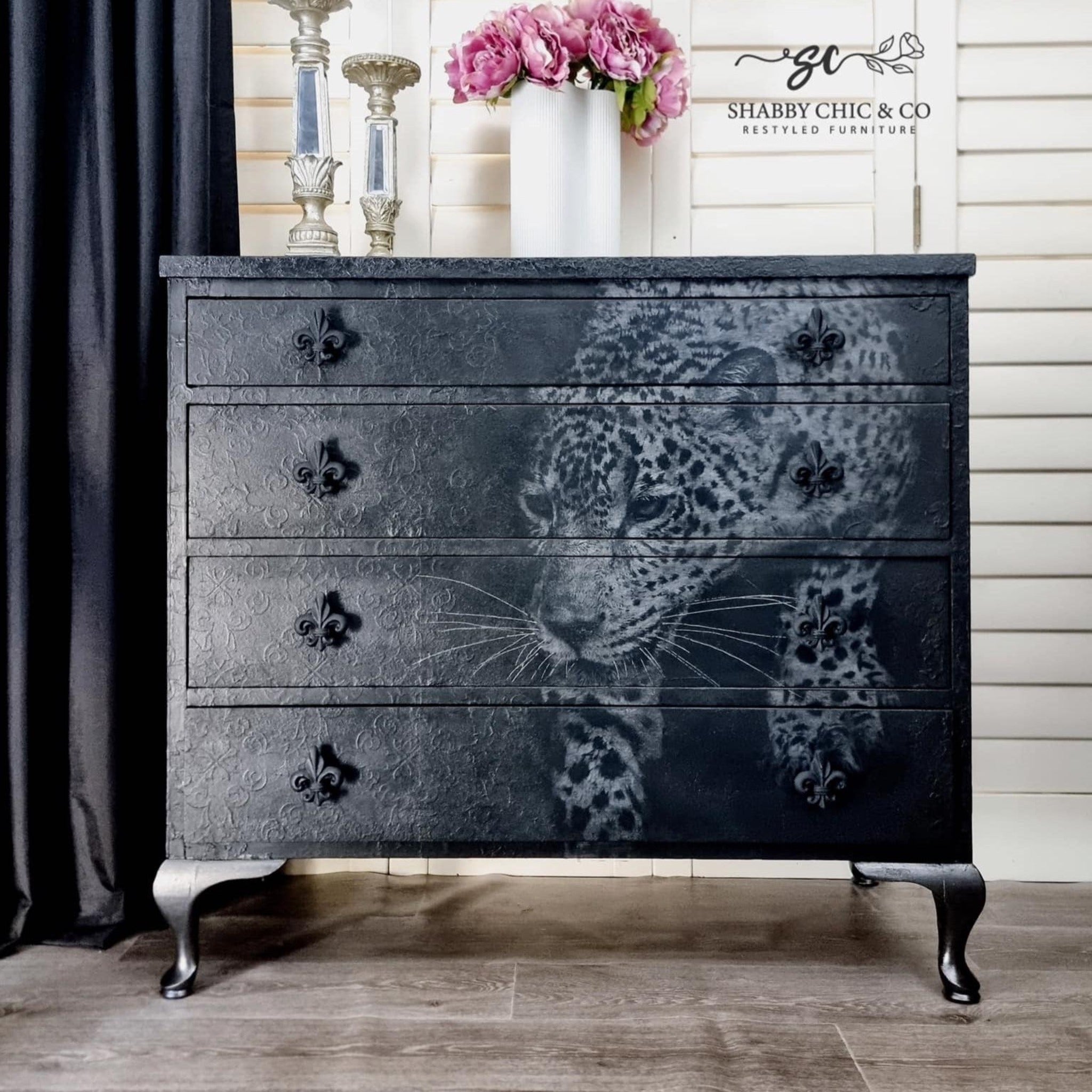 A vintage 4-drawer dresser refurbished by Shabby & Chic Co. is painted black and features ReDesign with Prima's Feline Gaze A1 fiber paper down the front right side.