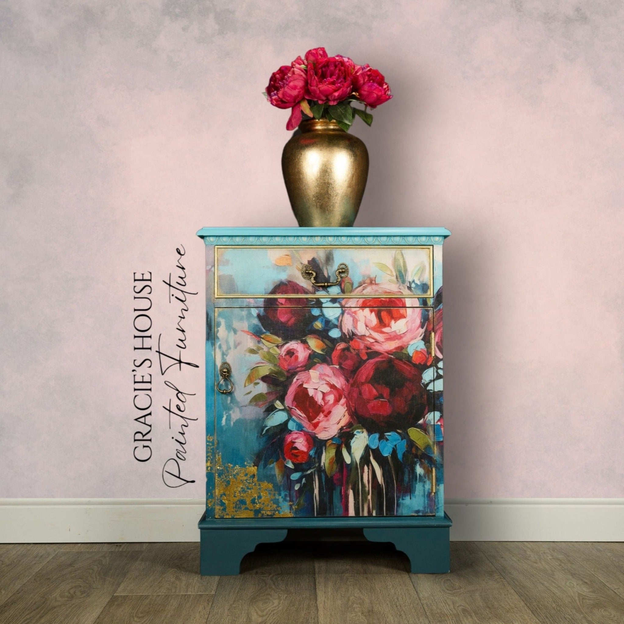 A vintage end table refurbished by Gracie's House Painted Furniture is painted an ombre of light to dark teal and features ReDesign with Prima's Burst of Color A1 fiber paper on its drawer and door.