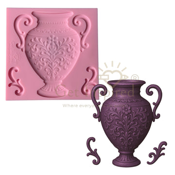 Pink silicone mold of a decorative vase next to a purple cast of the vase on a white background