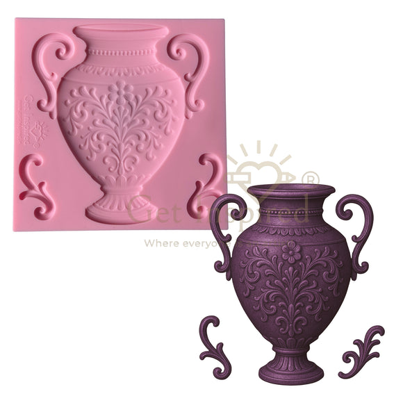Pink silicone mold of a decorative vase next to a purple cast of the vase on a white background