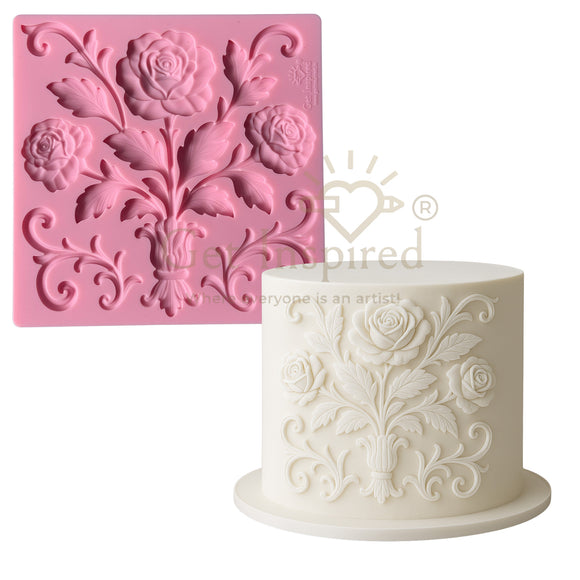 Silicone mold with floral design and a cake decorated with similar design on a white background