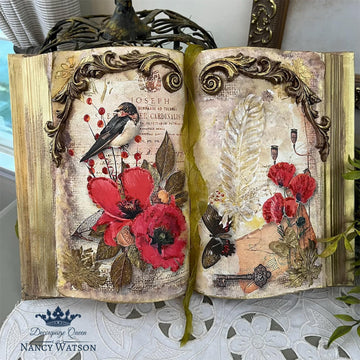 An open book turned into a decor piece features Decoupage Queen's Papillon Poppies rice paper on it.