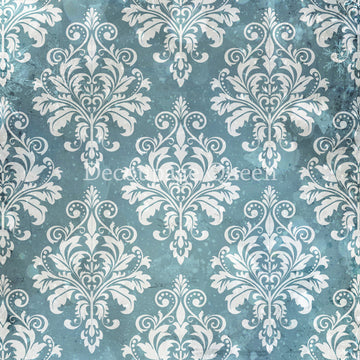 Close-up of a rice paper design that features a soft white flourish damask pattern against a wintery blue background.