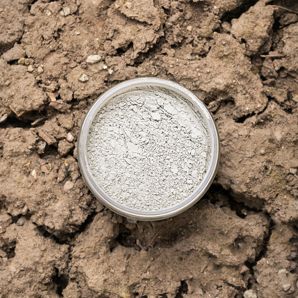 Gray Dixie Dirt in a container on dry soil