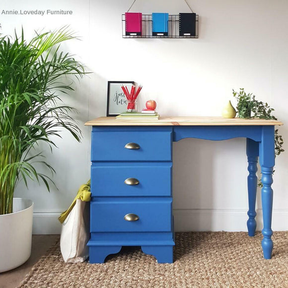 A vintage desk with 3 drawers refurbished by Annie Loveday Furniture features Dixie Belle's Cape Current Silk All-In-One Mineral Paint.