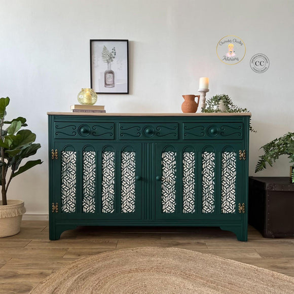 A large buffet cabinet refurbished by Cherubs Chalks Interiors features Dixie Belle's Midnight Green Silk All-In-One Mineral Paint.