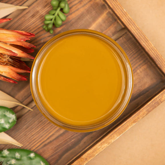 An arial view of an open container of Dixie Belle Paint Company's Mojave All-In-One Silk Paint is on a wood serving tray with cacti, succulents, and a dried orange colored flower.