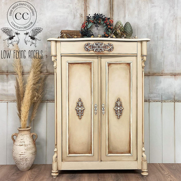 A vintage bar cabinet refurbished by Low Flying Angels features Dixie Belle's Sand Castle Silk All-In-One Mineral Paint.