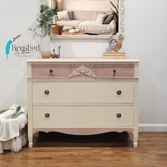 A 3-drawer dresser refurbished by Brushed by Maddie features Dixie Belle's Sand Castle Silk All-In-One Mineral Paint.