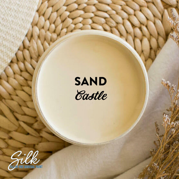 An arial view of an open container of Dixie Belle Paint Company's Sand Castle Silk All-In-One Mineral Paint is shown with black text reading Sand Castle.