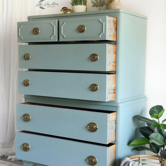A 6-drawer chest dresser refurbished by Lilly Moon Vintage features Dixie Belle's Serenity Silk All-In-One Mineral Paint.