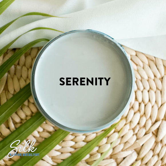 An arial view of an open container of Dixie Belle Paint Company's Serenity Silk All-In-One Mineral Paint is shown with black text reading Serenity.