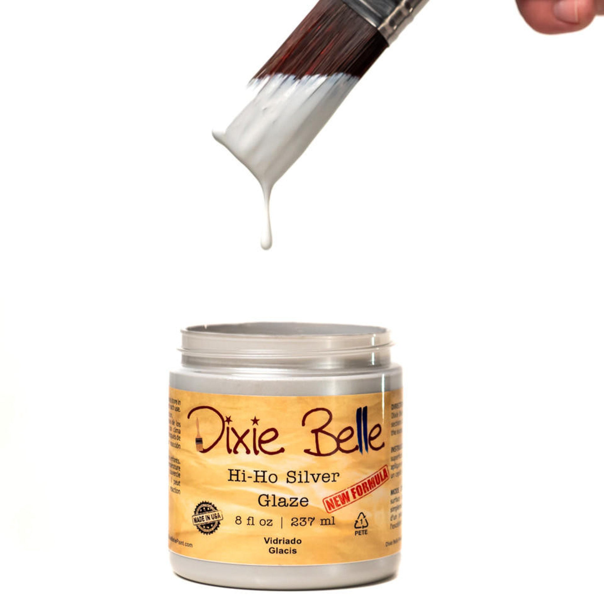 An open container of an 8oz/237ml Dixie Belle Hi Ho Silver Glaze with a dripping paintbrush above it is against a white background.