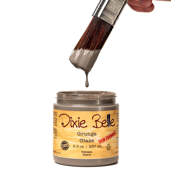 An open container of an 8oz/237ml Dixie Belle Grunge Glaze with a dripping paintbrush above it is against a white background.