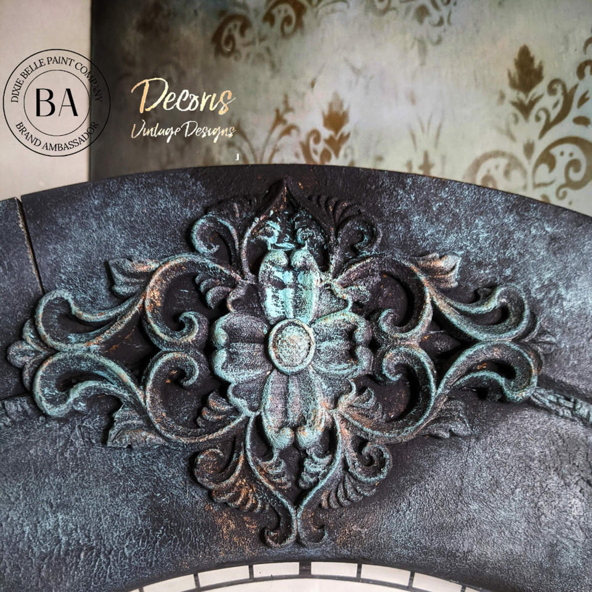 Close-up of a silicone mould casting of a large ornate medallion created by Decoris Vintage Designs is painted with Dixie Belle's Patina Paints over black paint.