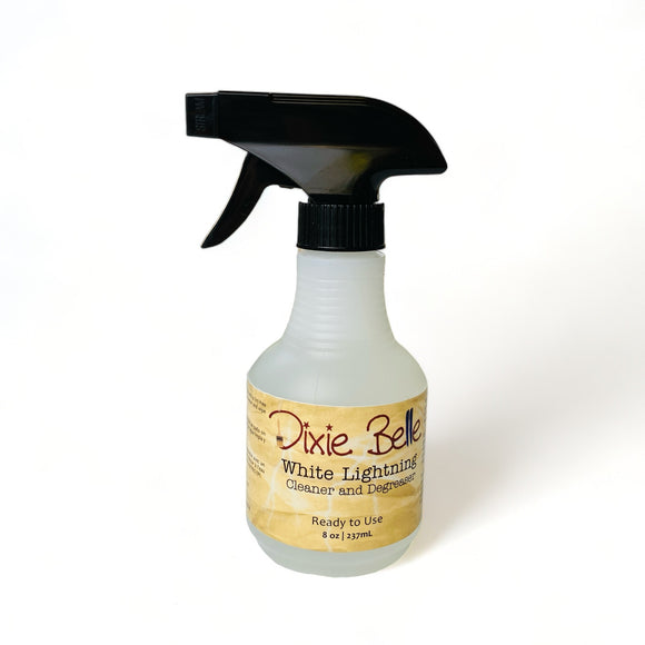 An 8 ounce spray bottle of Dixie Belle Paint's White Lightning Cleaner and Degreaser is against a white background.