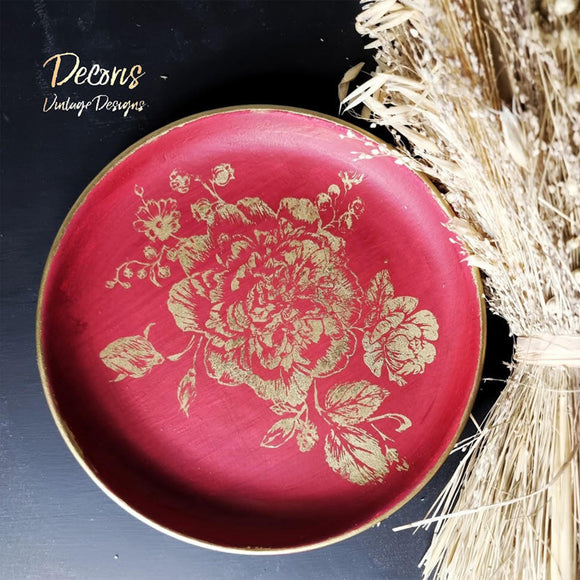 A round wood tray refurbished by Decoris Vintage Designs features Dixie Belle's Fiery Sky Silk All-In-One Mineral Paint with a gold flower stencil design.
