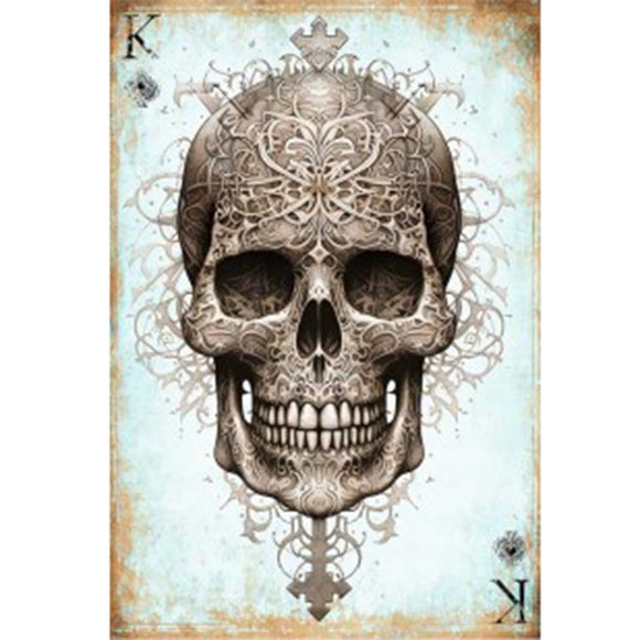 Full sheet of 'King of Skulls' decoupage paper from Paper Designs Italy, displaying an elaborately decorated skull with filigree patterns and crown elements. Set against a vintage, blue-weathered background with 'K' and spade symbols in the corners.
