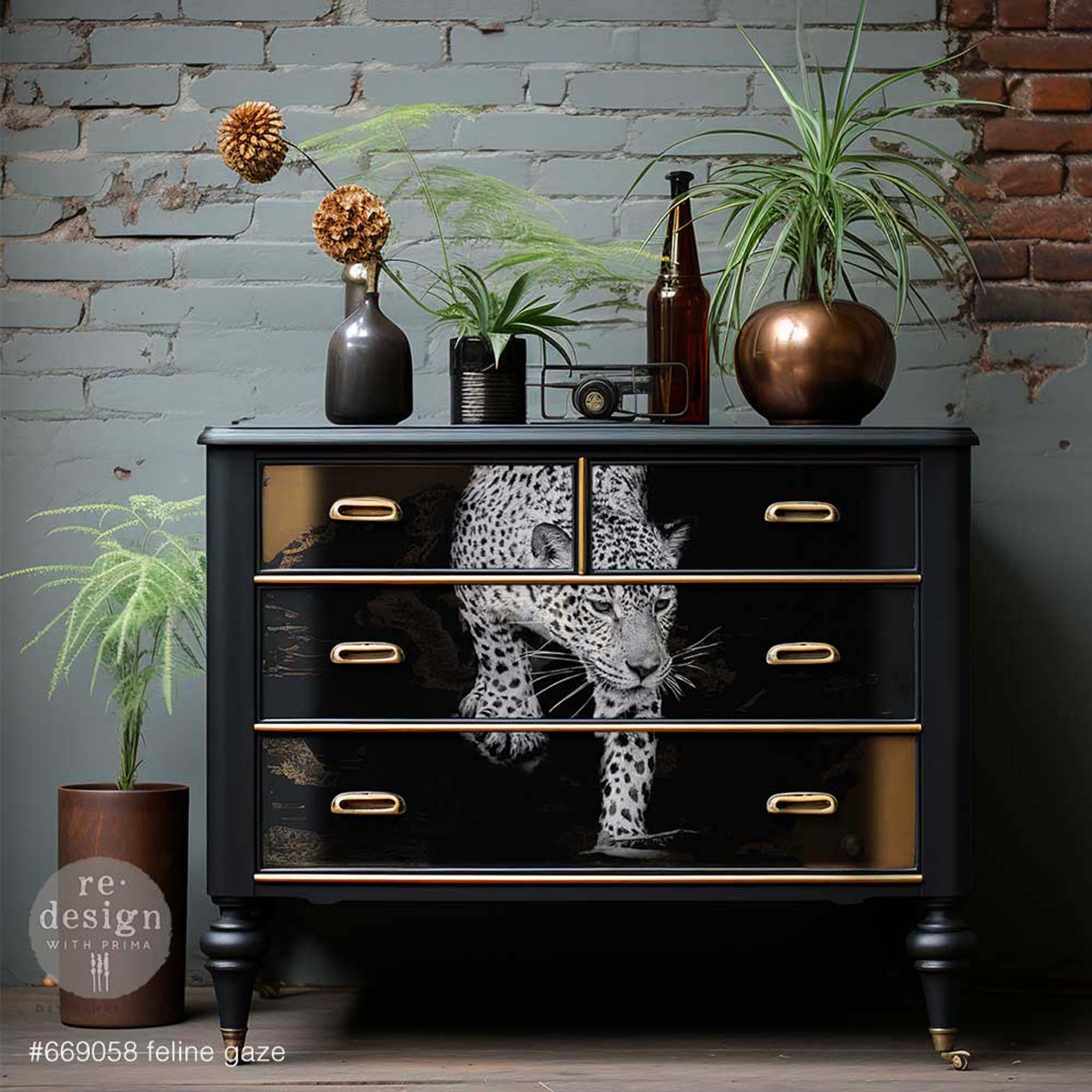 A dresser is painted black with gold accents and features ReDesign with Prima's Feline Gaze A1 fiber paper in the center of its 4 drawers.