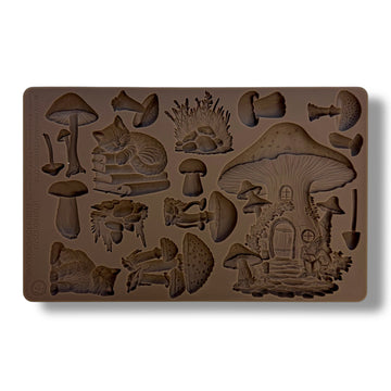 A brown silicone mold of mushrooms, a fairy mushroom house, and cats is against a white background.
