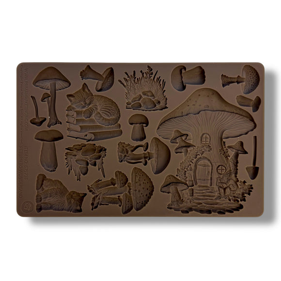 A brown silicone mold of mushrooms, a fairy mushroom house, and cats is against a white background.