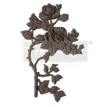 A flexible decor poly casting featuring a thorned branch of 2 roses with leaves facing left is against a white background.