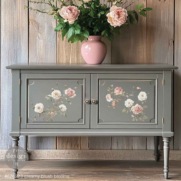A vintage console table with storage is painted grey and features ReDesign with Prima's Creamy Blush Blooms small rub-on transfers on its 2 doors.