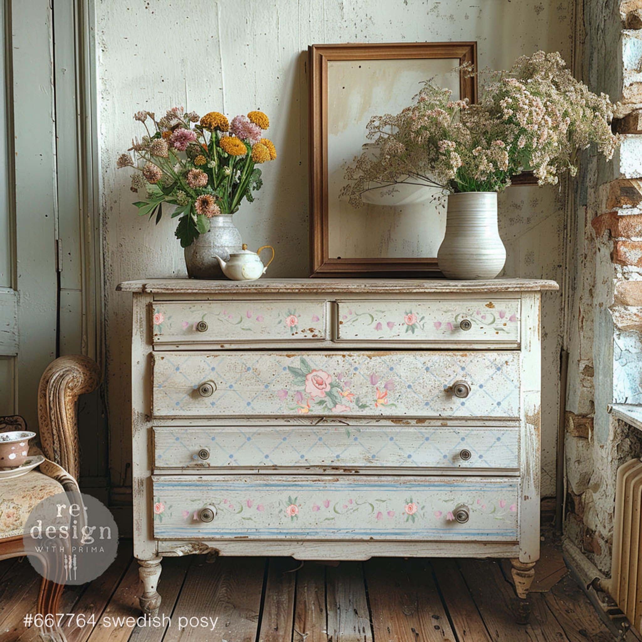 A vintage 5-drawer dresser is painted in white wash and features ReDesign with Prima's Swedish Posy Transfer by Annie Sloan on its drawers.