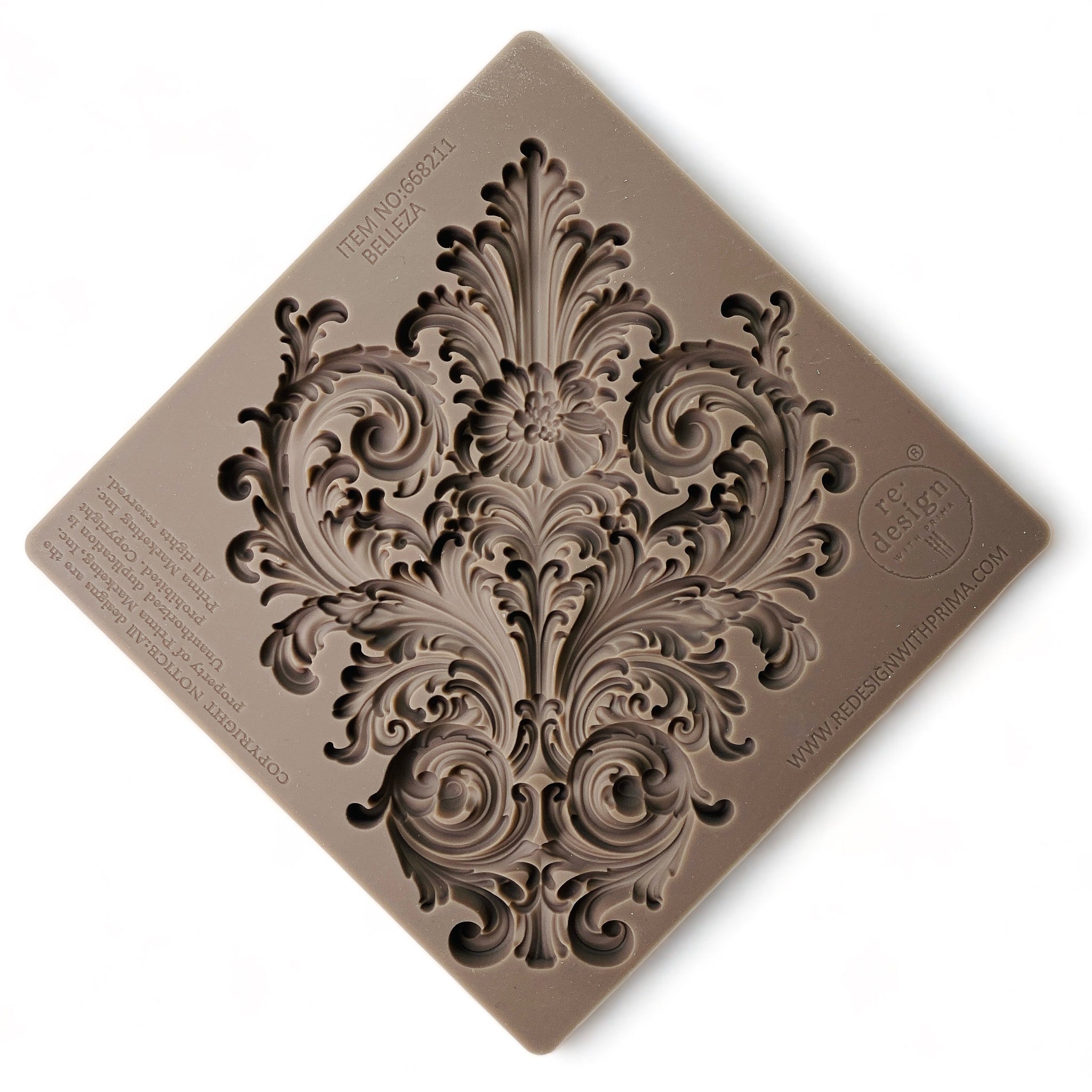 A brown silicone mold of an ornate leaf scroll design is against a white background.