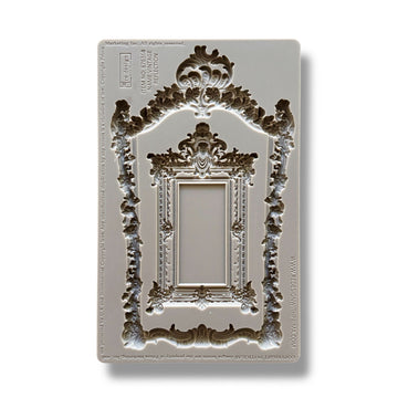 A silicone mold featuring an intricate frame and smaller solid mirror-like frame is against a white background.