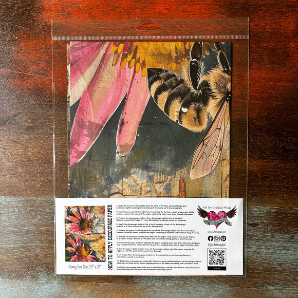 A package of Whimsykel's Honey Bee tissue paper is against a dark wood background.