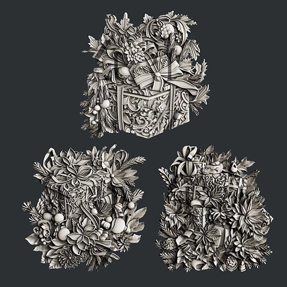 Silver colored silicone mold castings featuring 3 ornately decorated gift boxes covered in holiday bouquets are against a dark grey background.