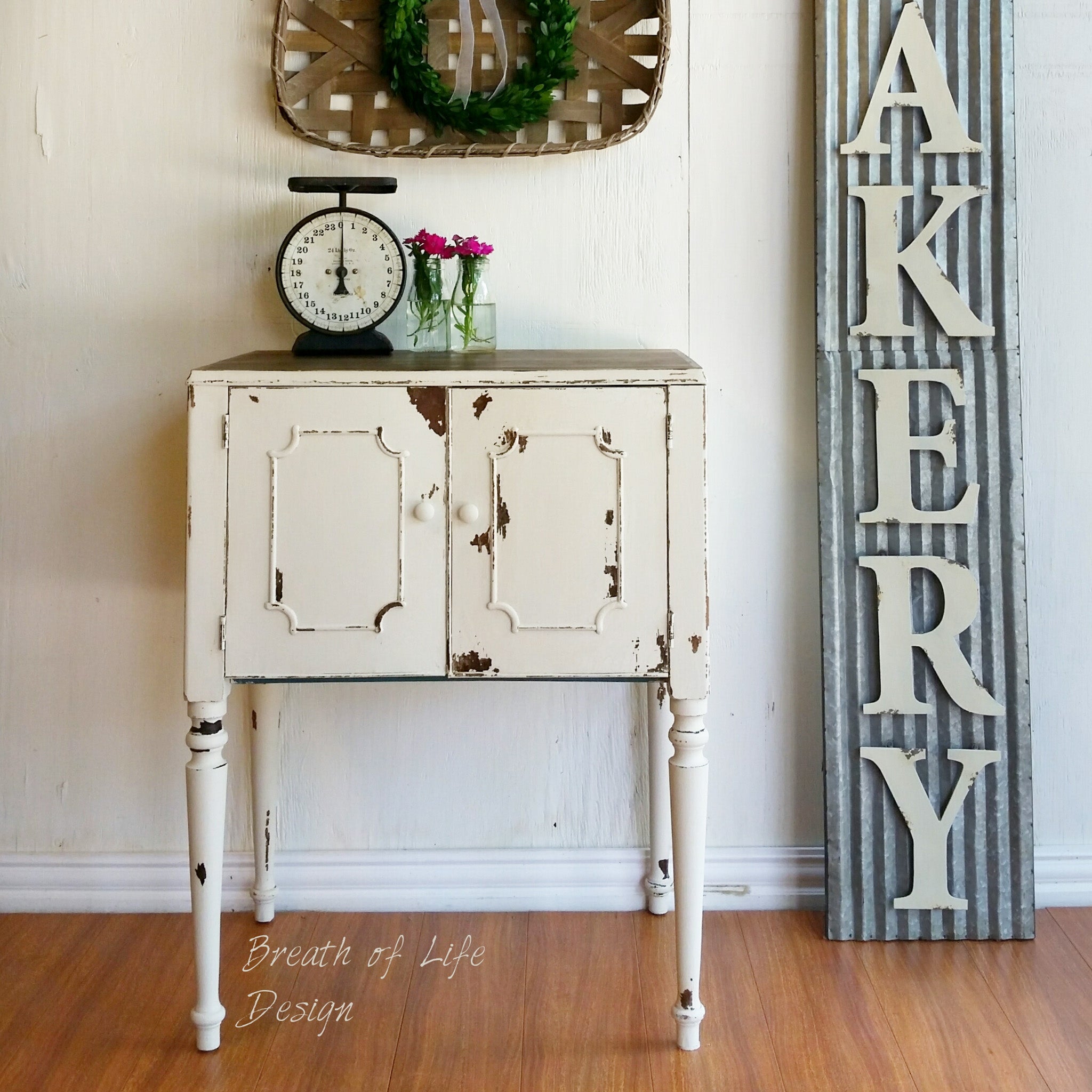 A small vintage entry-way console table refurbished by Breath of Life Design is painted in Dixie Belle's Drop Cloth chalk mineral paint and has been distressed.
