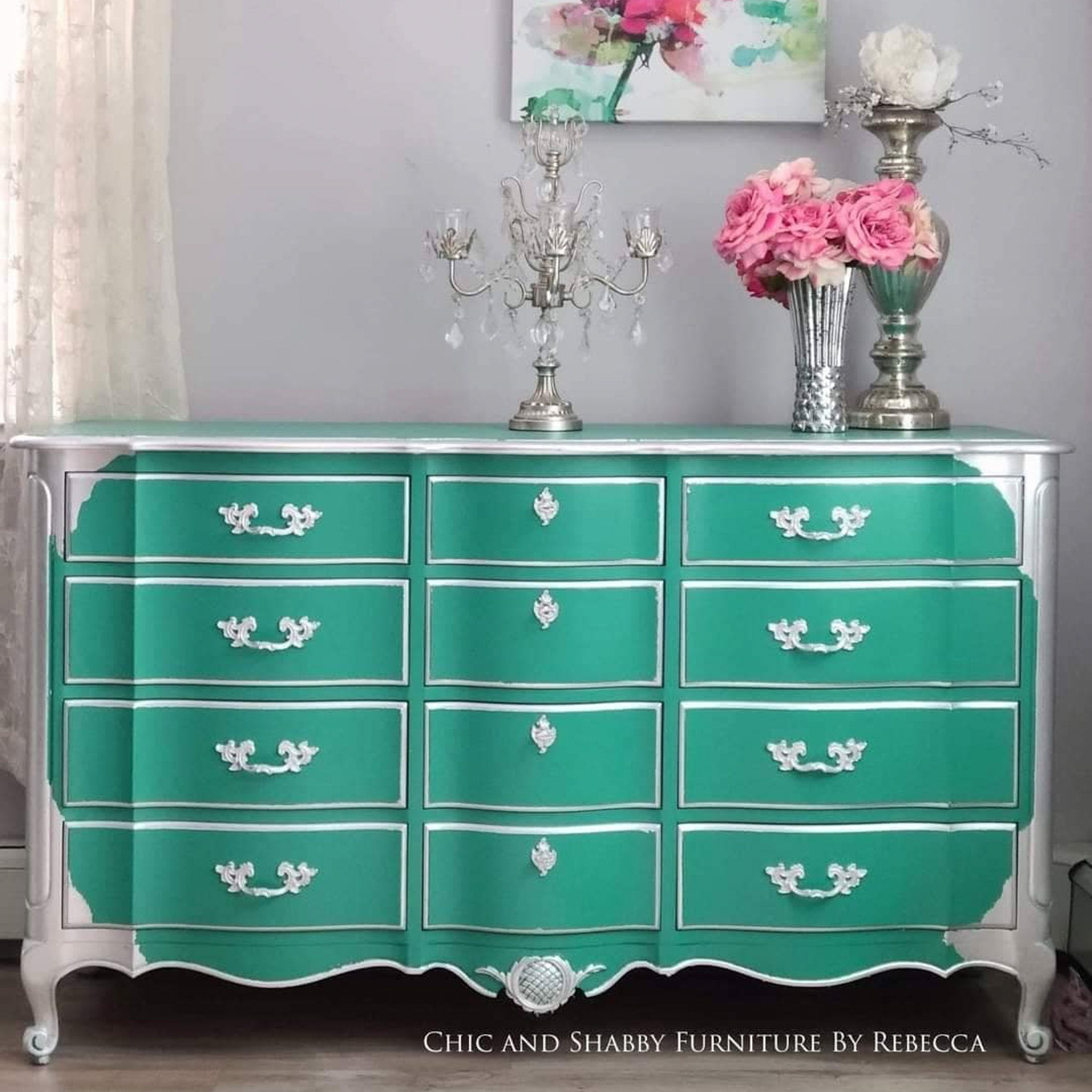 A vintage 12-drawer dresser refurbished by Chic and Shabby Furnitue by Rebecca is painted in Dixie Belle's Mermaid Tail chalk mineral paint and has a surrounding framing paint of silver.