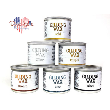 Six small cans of Dixie Belle Paint Company's Gilding Waxes in Gold, Silver, Copper, Bronze, Zinc, and Black are against a white background.