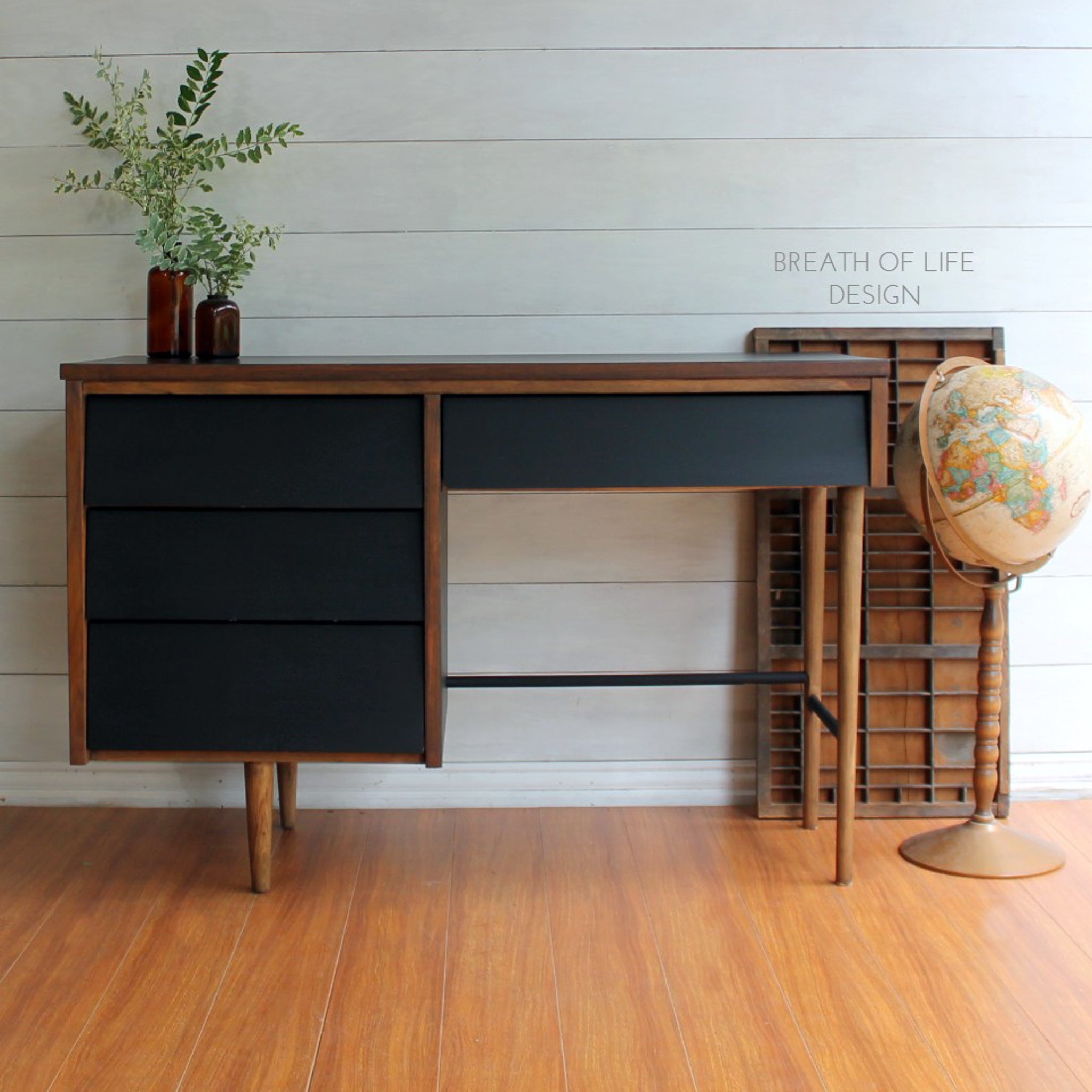 A mid-century desk refurbished by Breath of Life Design is stained a natural wood color and features Dixie Belle's Caviar chalk mineral paint.