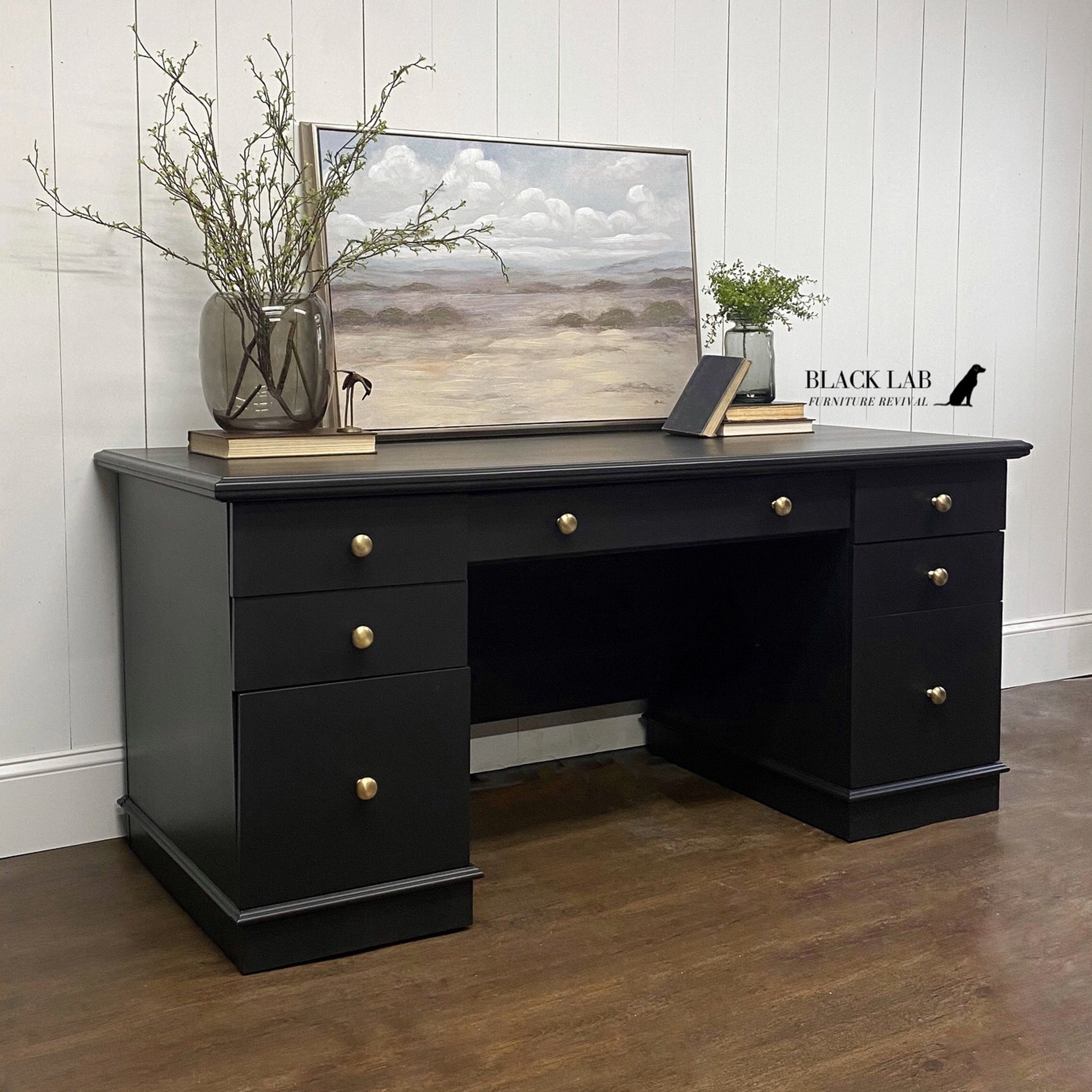 A large office desk refurbished by Black Lab Furniture Revival is painted in Dixie Belle's Caviar chalk mineral paint.