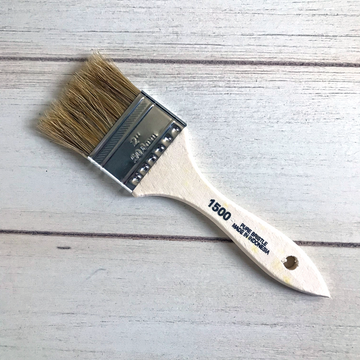 An arial view of a paint brush on a table. On it, it says 2", 50.8mm. 1500. Pure bristle. Made in Indonesia.