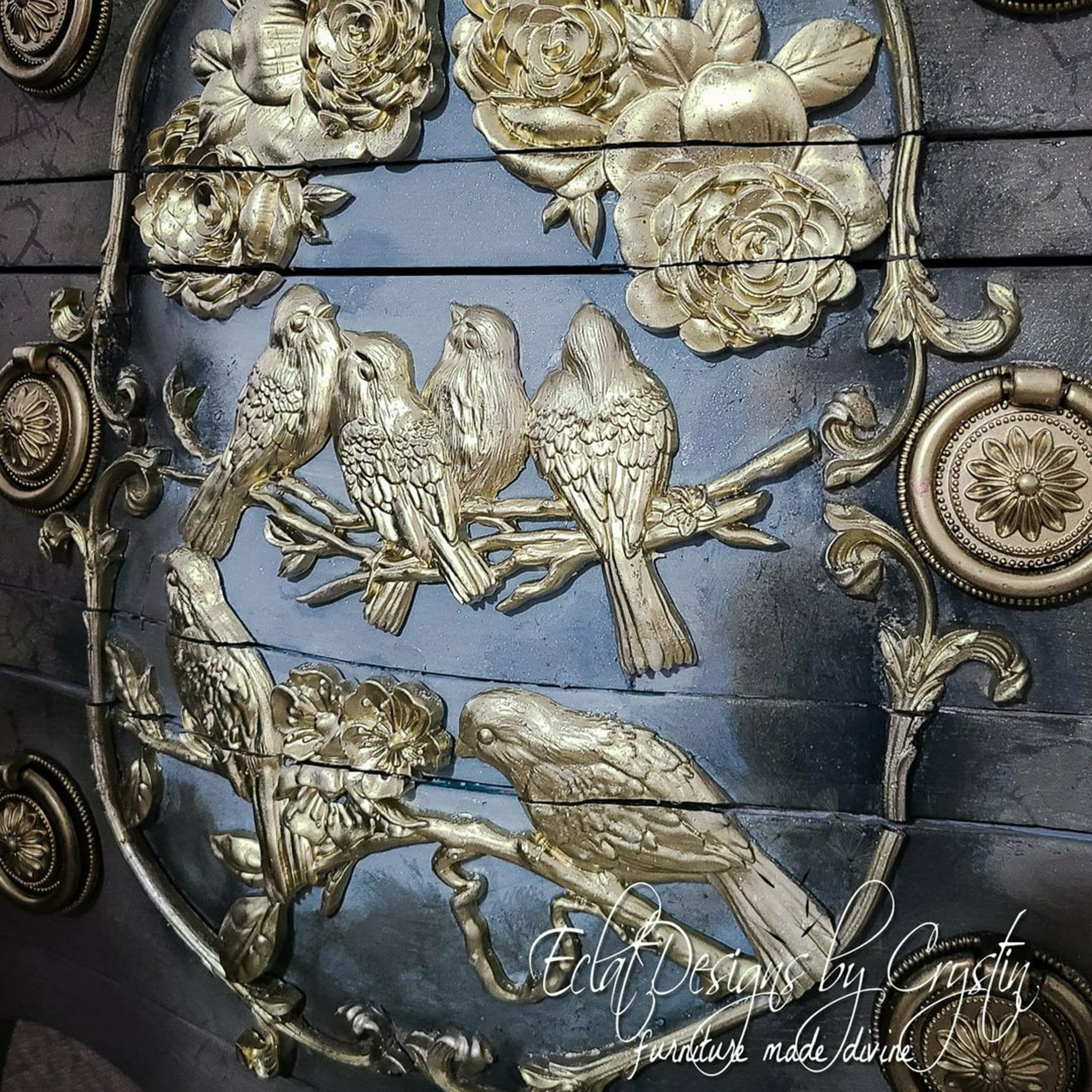 A close up of a black dresser with the blossoming spring and Victorian mold in gold. A white logo in the bottom right corner reading: Eclat designs by Crystin furniture made divine.