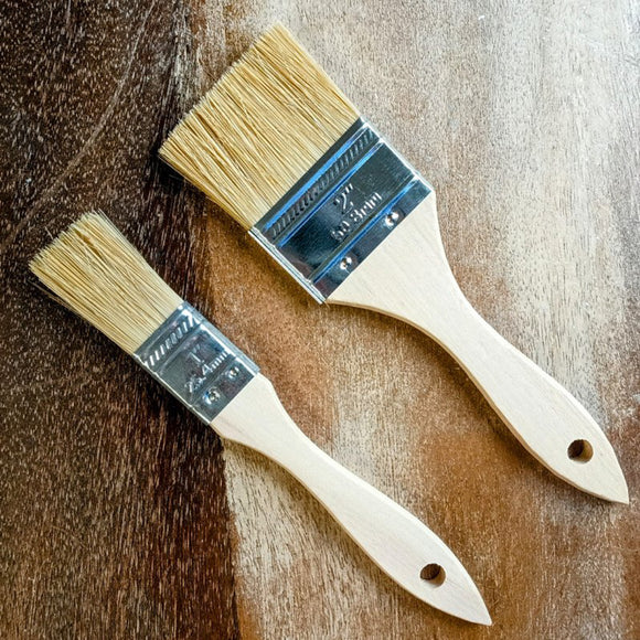 1 inch and 2 inch pure bristle chip paint brushes shown together on a wood background