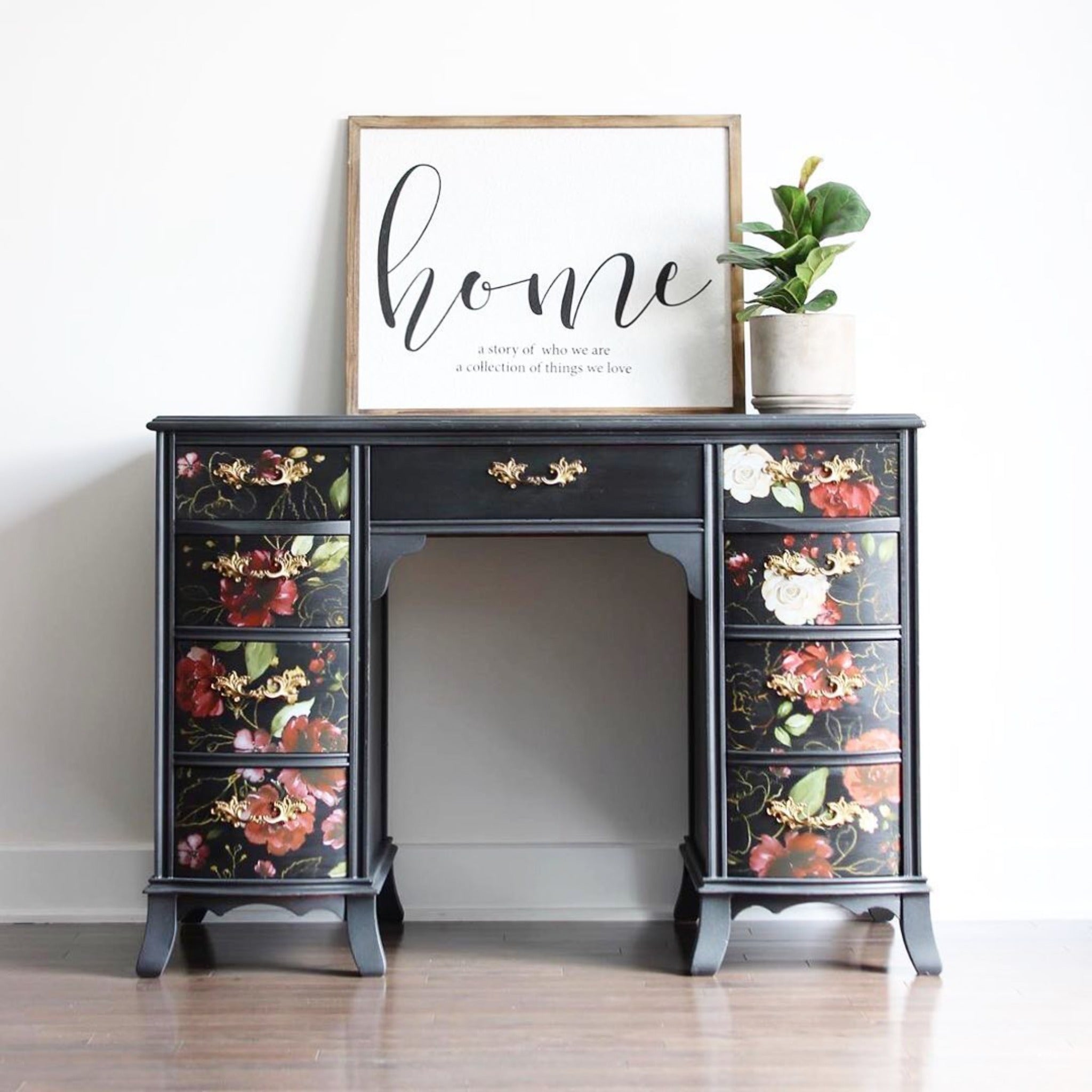 A vintage vanity desk is painted black and features ReDesign with Prima's Midnight Floral transfer on its 8 small drawers.