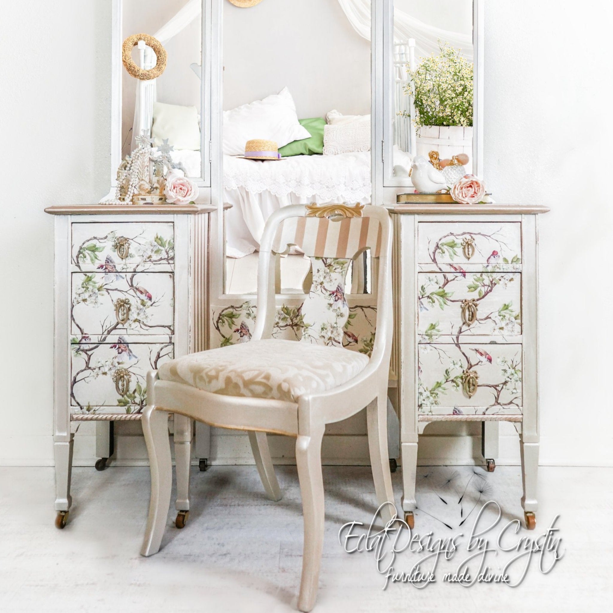 A vintage vanity desk refurbished by Eclat Designs by Crystin is painted white with champagne gold accents and features ReDesign with Prima's Blossom Flight transfer on it.