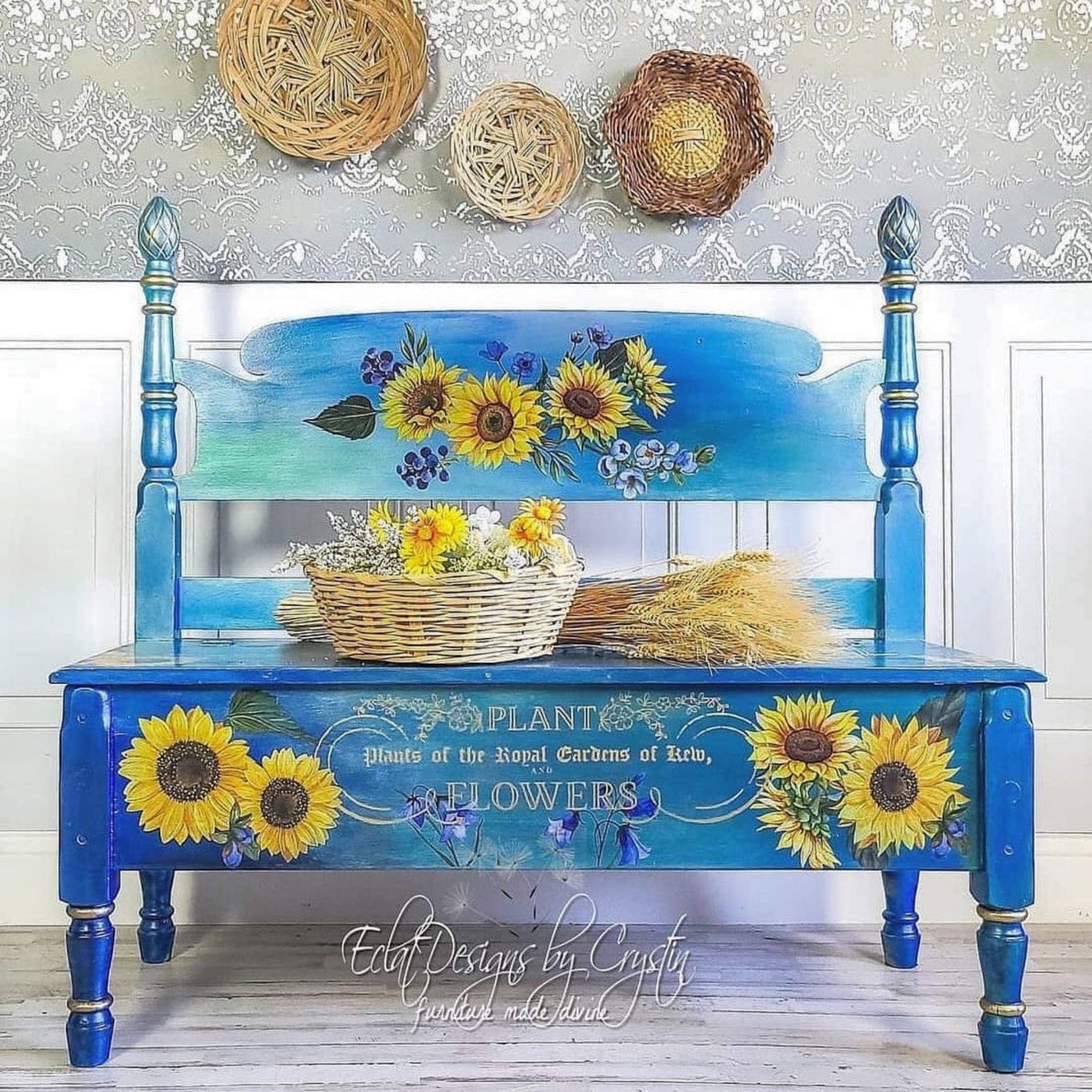A vintage headboard and footboard turned into a bench refurbished by Eclat Designs by Crystin is painted blue with a touch of blended green and features ReDesign with Prima's Sunflower Fields transfer on it.