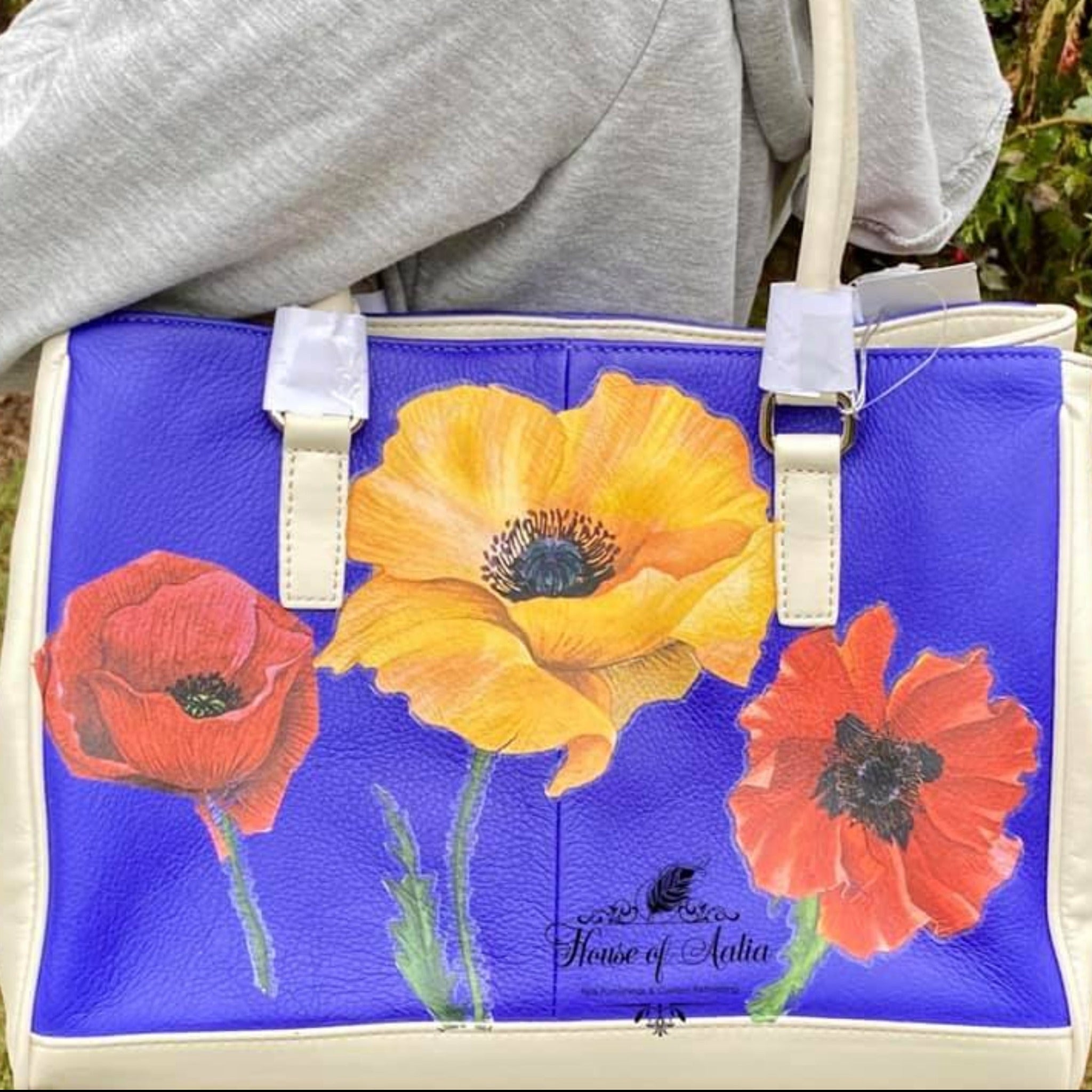 A leather purse refurbished by House of Aalia is painted bright blue and features 3 large poppies of ReDesign with Prima's Poppy Gardens transfer.