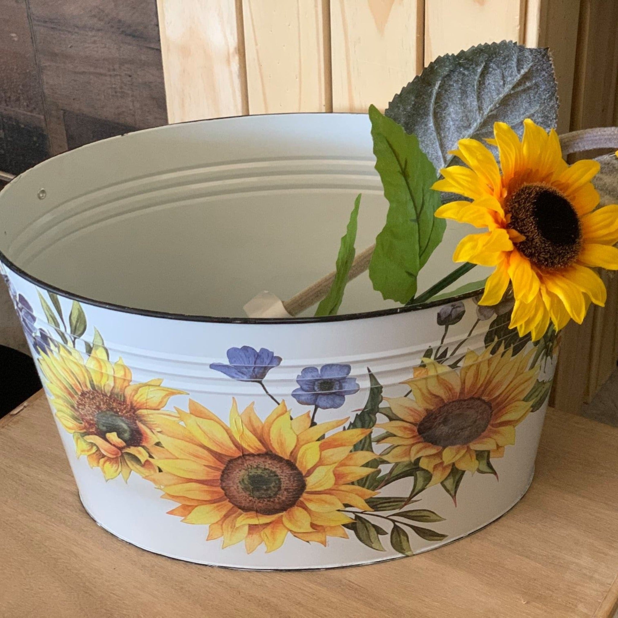 A white metal wash basin features ReDesign with Prima's Sunflower Fields transfer on it.