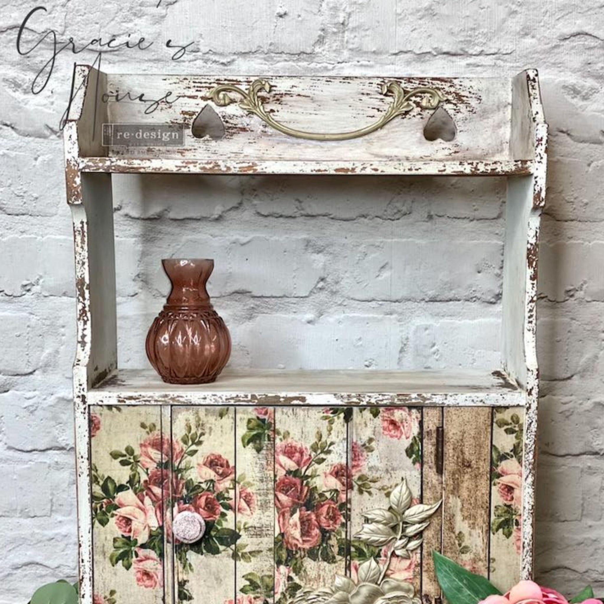 A vintage small bathroom cabinet with a hutch style shelf refurbished by Gracie's House is painted a very distressed white and features ReDesign with Prima's Shabby Floral tissue paper on its door.